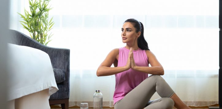 vitality-in-room_woman-doing-yoga-in-guestroom-1-2
