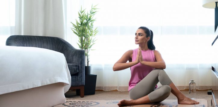 vitality-in-room_woman-doing-yoga-in-guestroom-2
